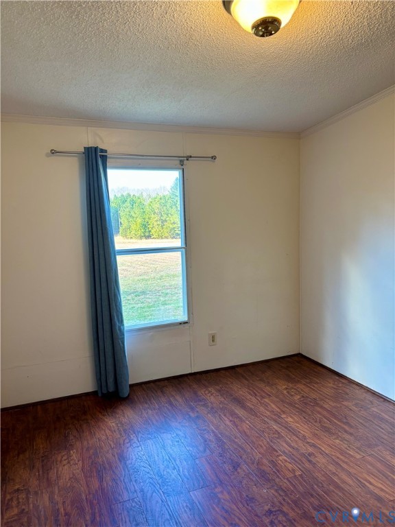 1225 Beech Forest Road Kenbridge, VA 23944 - Photo 16 of 33 an empty room with wooden floor and windows