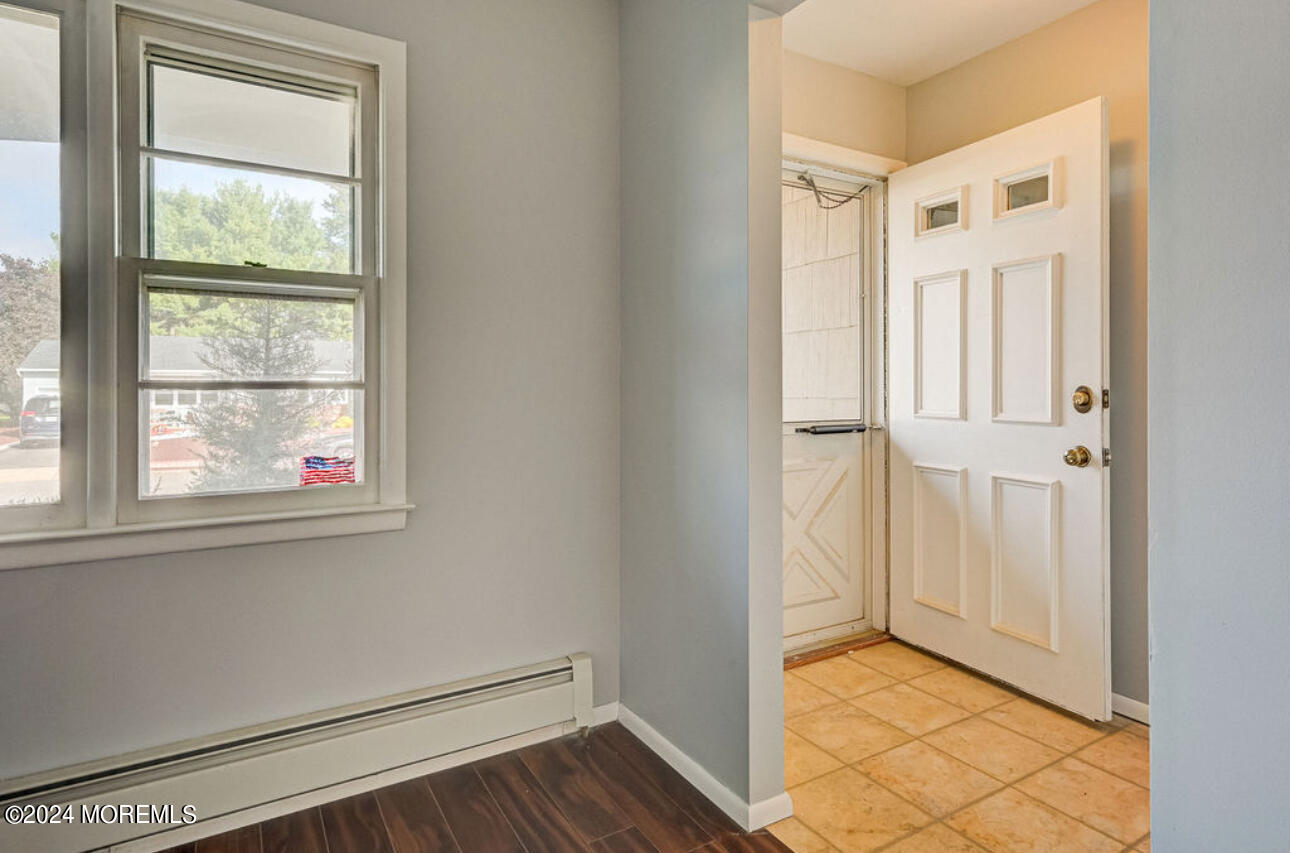 5 Coventry Road Toms River, NJ 08757 - Photo 6 of 27 an empty room with wooden floor and windows
