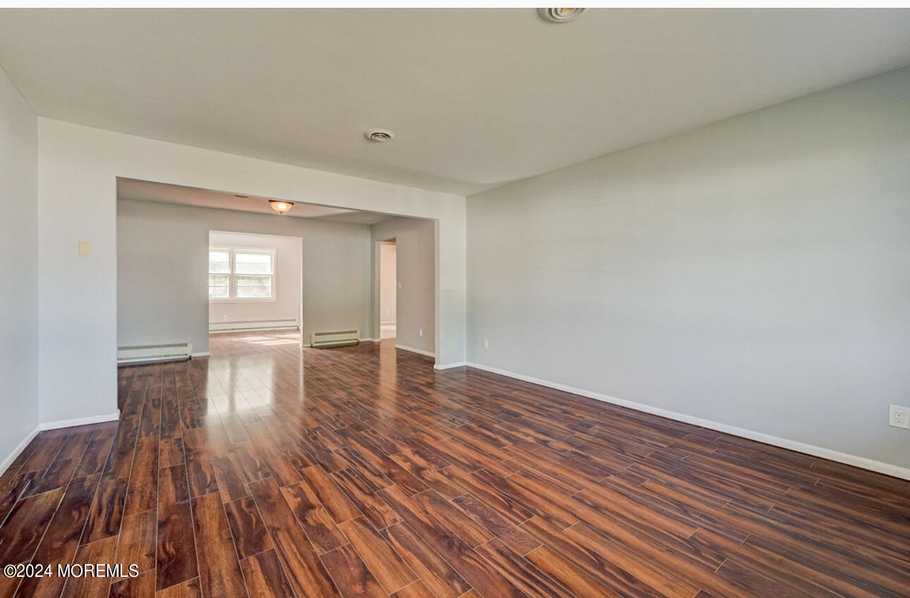 5 Coventry Road Toms River, NJ 08757 - Photo 7 of 27 a view of empty room with wooden floor and fan