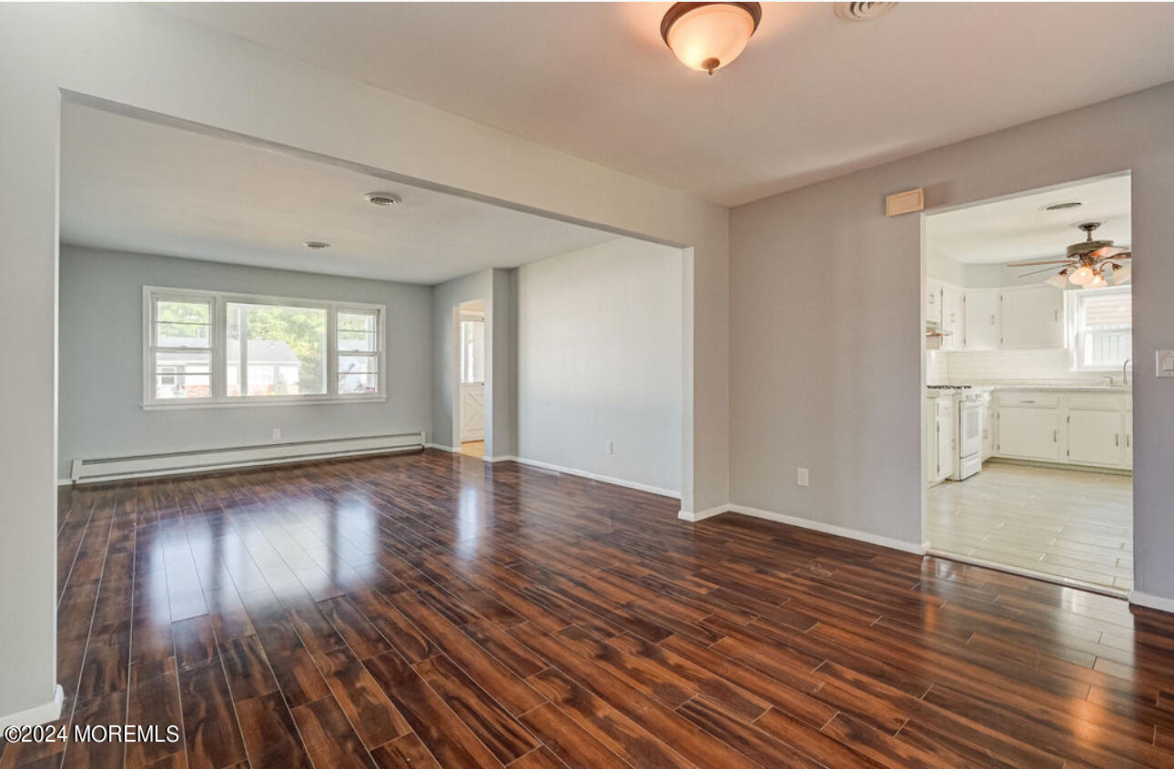 5 Coventry Road Toms River, NJ 08757 - Photo 8 of 27 an empty room with wooden floor and windows