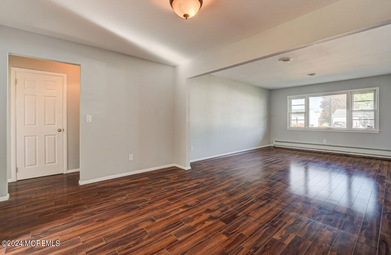5 Coventry Road Toms River, NJ 08757 - Photo 9 of 27 an empty room with wooden floor and windows