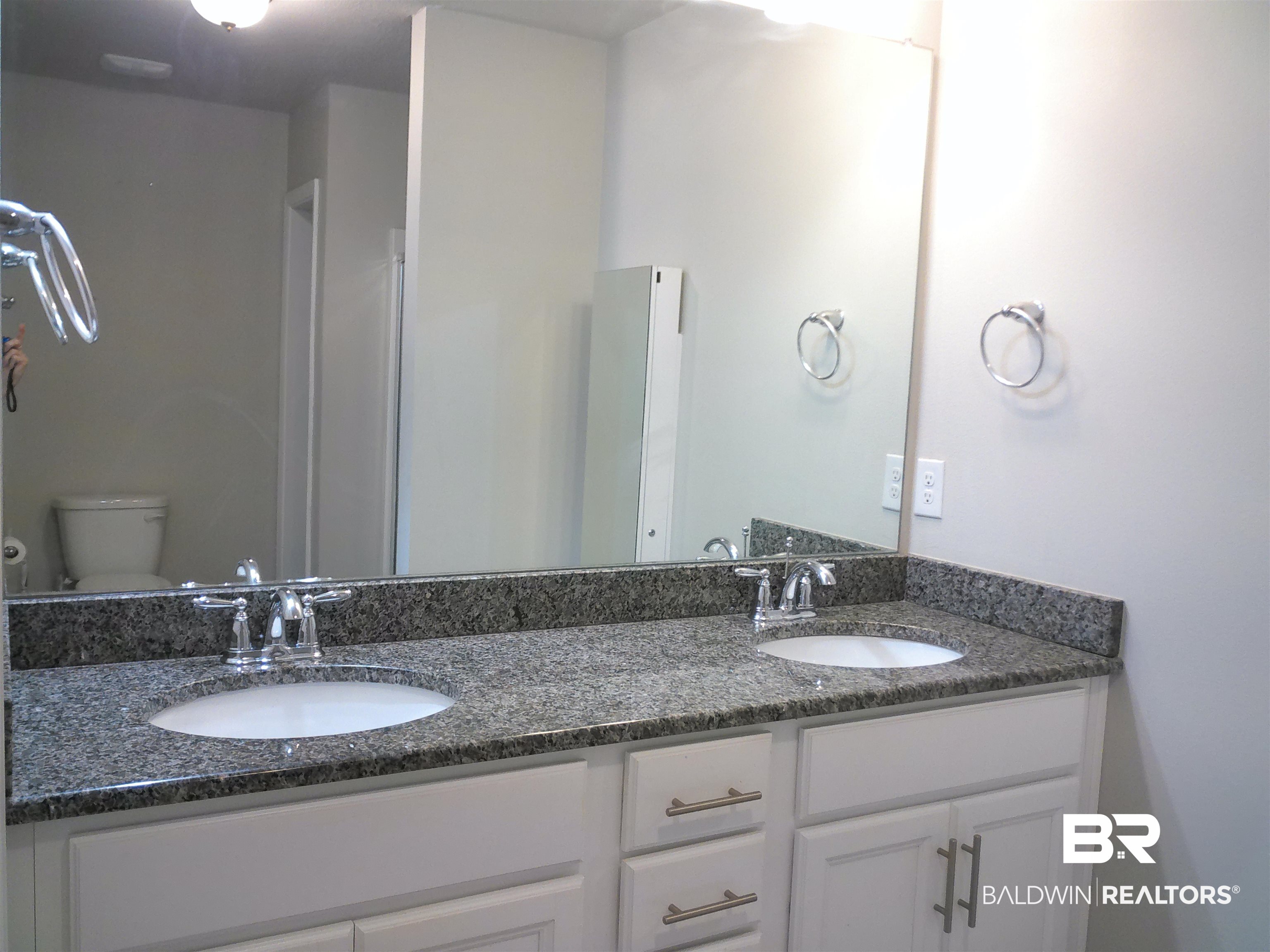 25806 Pollard Road, Unit 23 Daphne, AL 36526 - Photo 5 of 16 Bathroom featuring toilet and double vanity