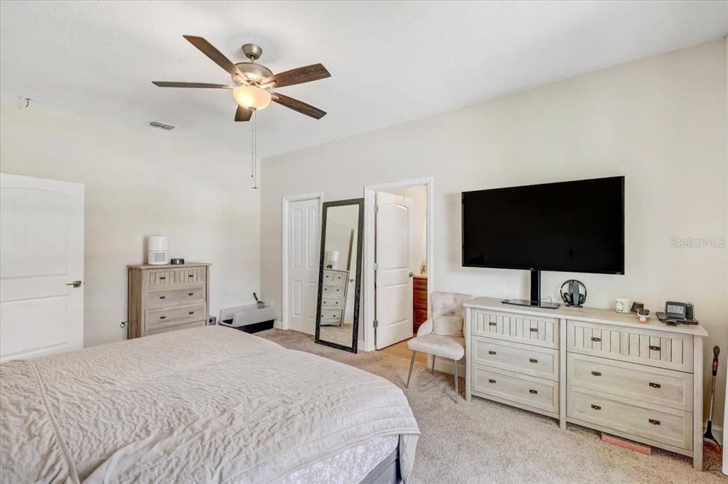 7314 Madrid Road Weeki Wachee, FL 34613 - Photo 19 of 54 a bedroom with a bed and a flat screen tv