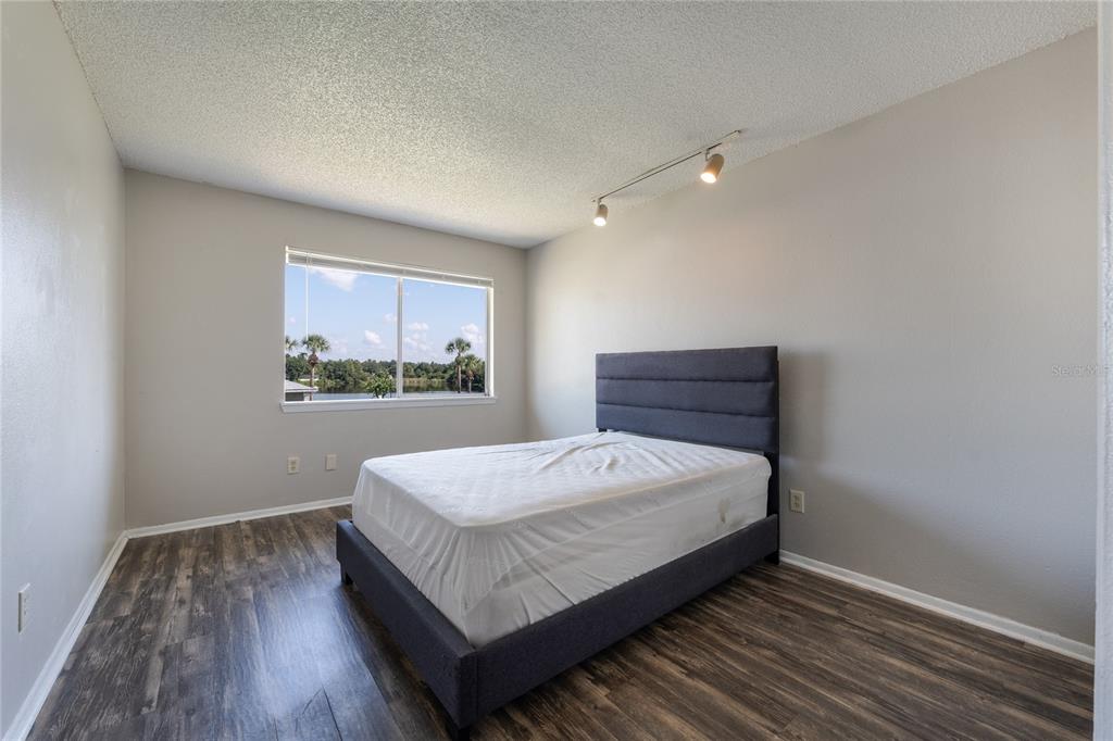 4413 Ring Neck Road, Unit 4413 Orlando, FL 32808 - Photo 11 of 24 a bed sitting in a spacious bedroom next to a window