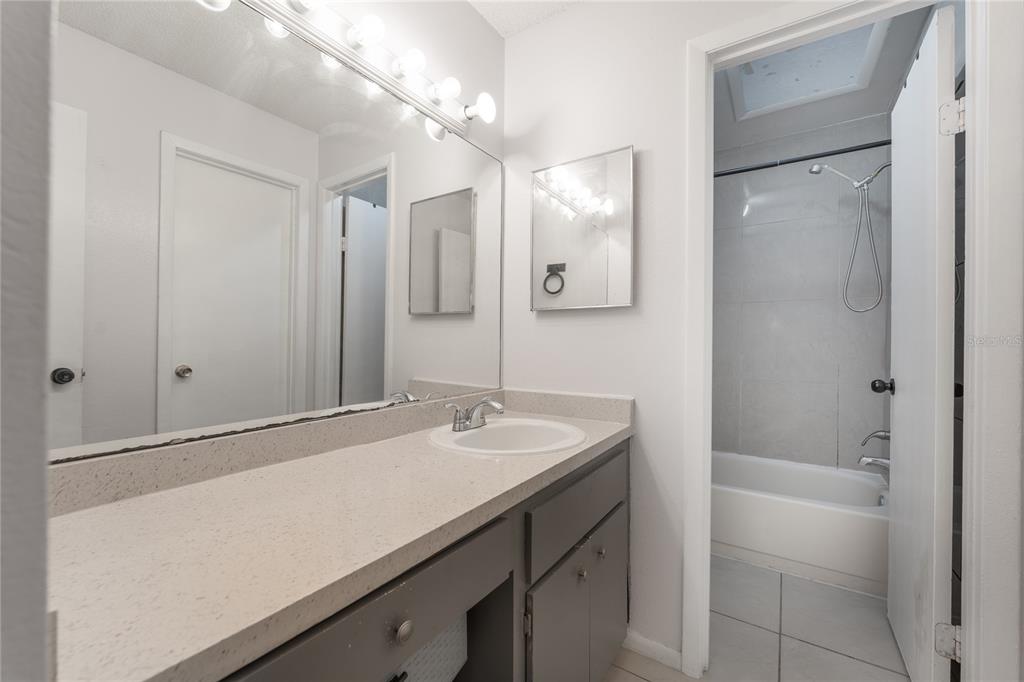 4413 Ring Neck Road, Unit 4413 Orlando, FL 32808 - Photo 15 of 24 a bathroom with a sink a vanity and a mirror