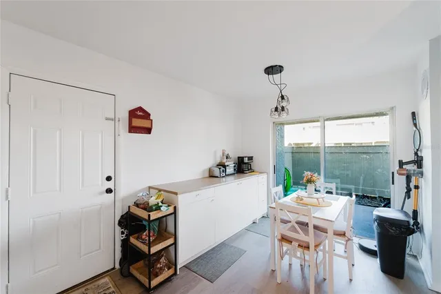 a dining room with furniture and a window