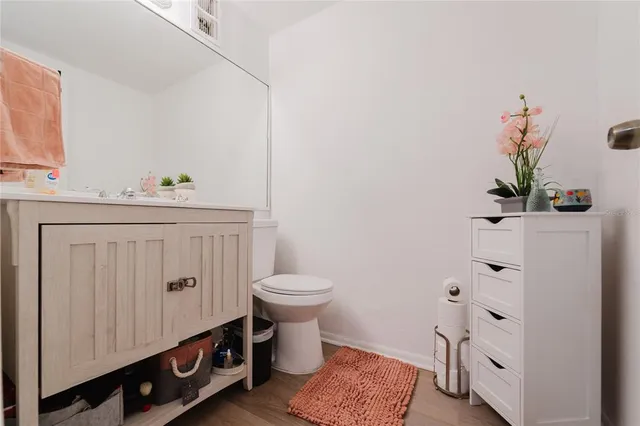 a bathroom with a sink a toilet and vanity