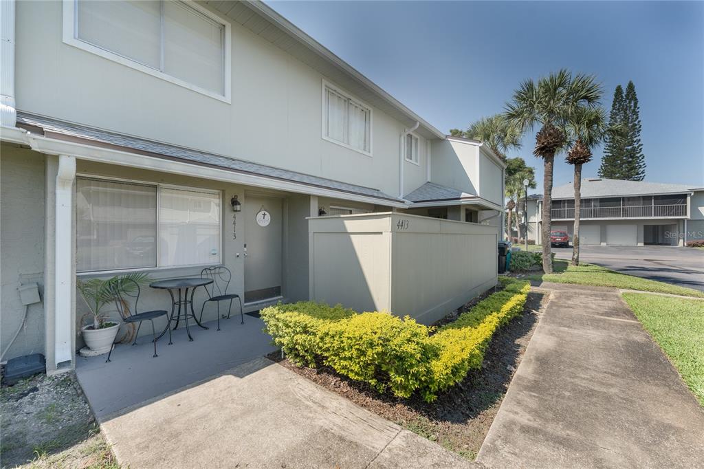 4413 Ring Neck Road, Unit 4413 Orlando, FL 32808 - Photo 2 of 24 a swimming pool with outdoor seating and yard