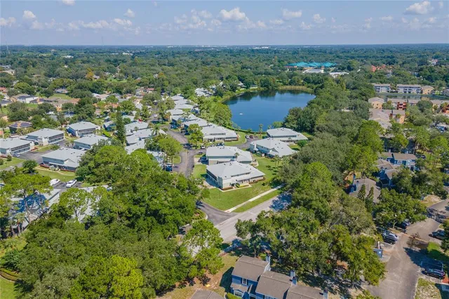 an aerial view of residential houses with outdoor space and lake view