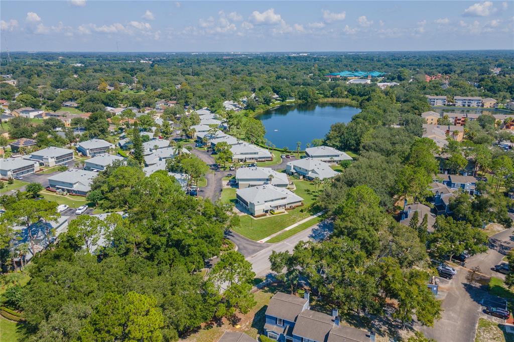 4413 Ring Neck Road, Unit 4413 Orlando, FL 32808 - Photo 23 of 24 an aerial view of residential houses with outdoor space and lake view