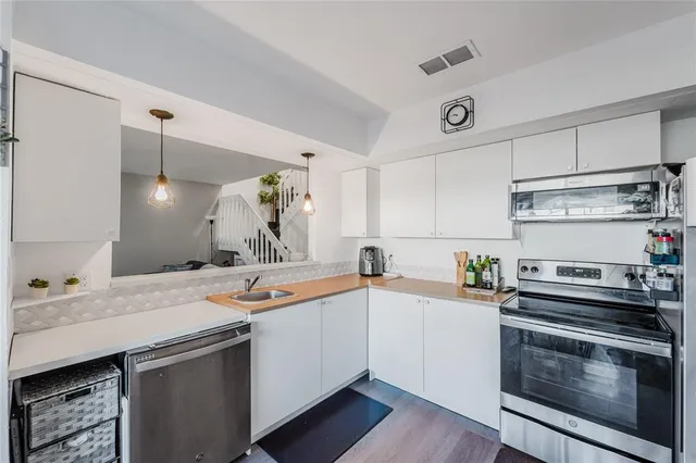 a kitchen with a sink stove and cabinets