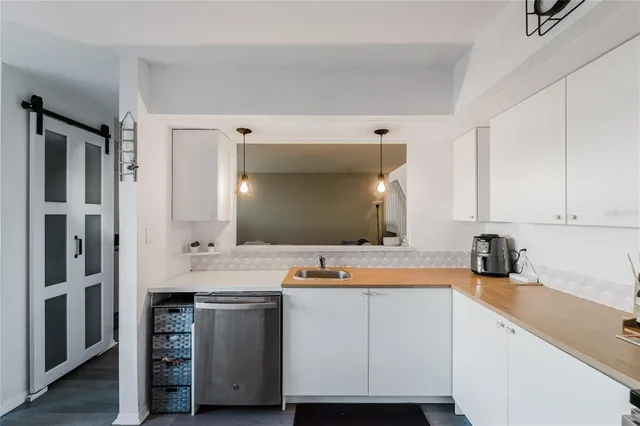 a kitchen with a sink cabinets and stainless steel appliances