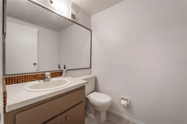 a bathroom with a sink toilet and a mirror