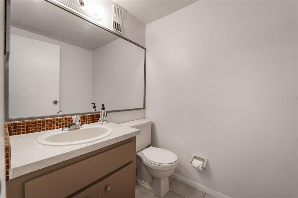 4413 Ring Neck Road, Unit 4413 Orlando, FL 32808 - Photo 10 of 24 a bathroom with a sink toilet and a mirror