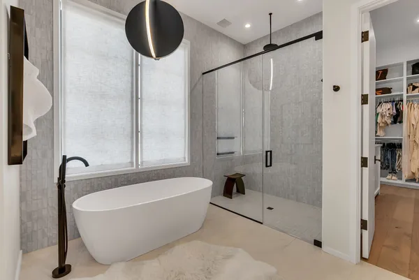 a bathroom with a bathtub and a potted plant