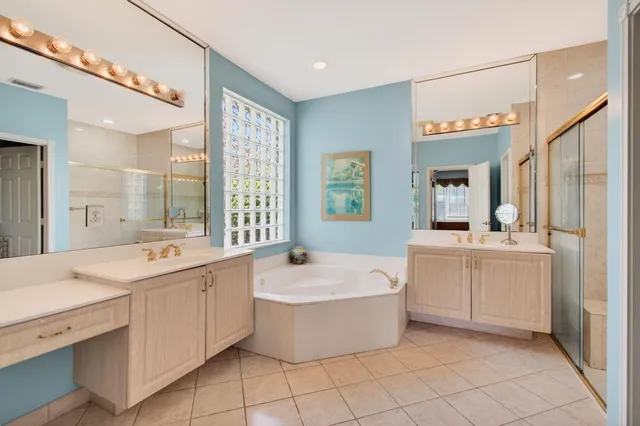 a bathroom with a double vanity sink mirror and shower