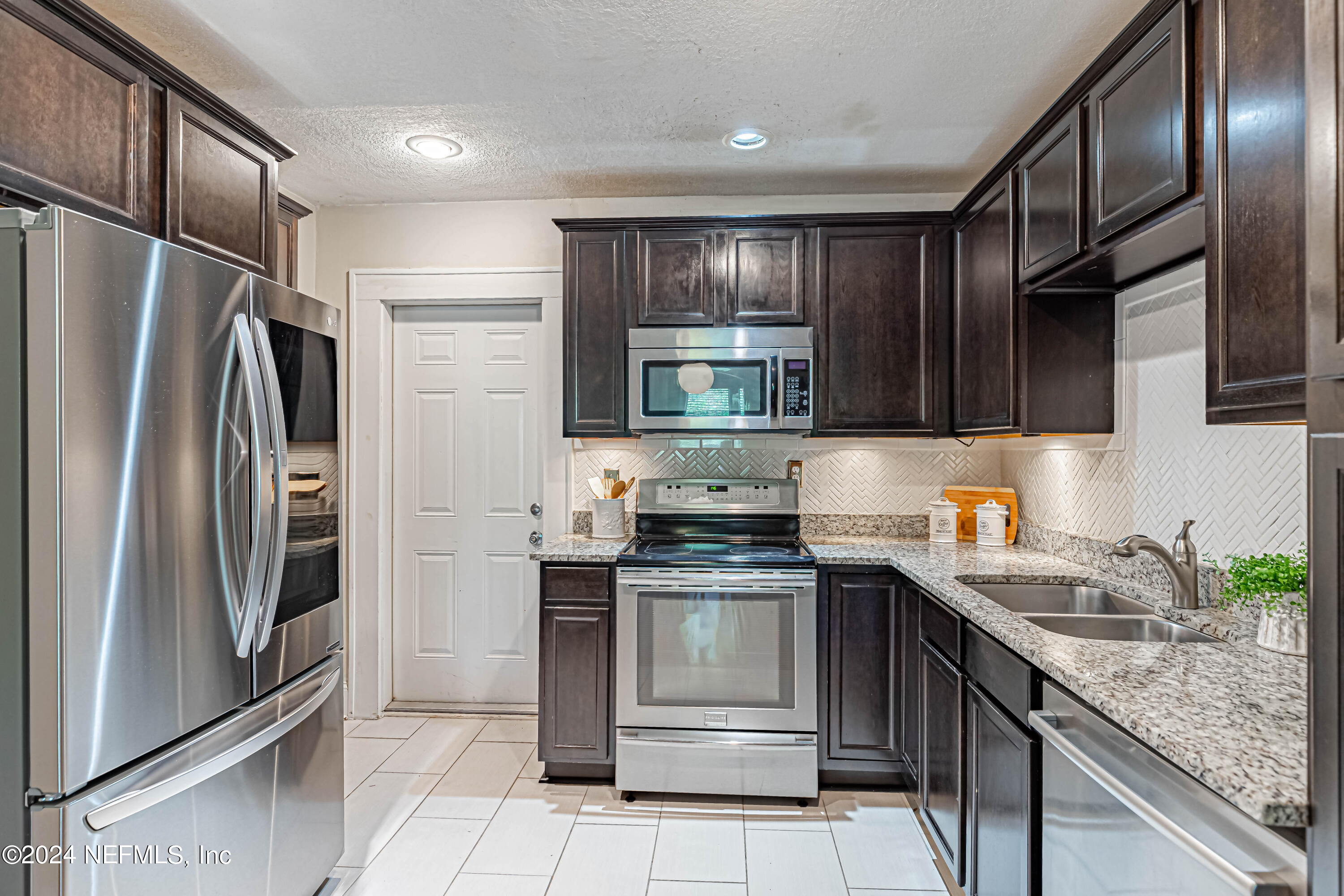 725 Cherokee Street Jacksonville, FL 32205 - Photo 15 of 41 a kitchen with stainless steel appliances granite countertop a refrigerator stove and sink