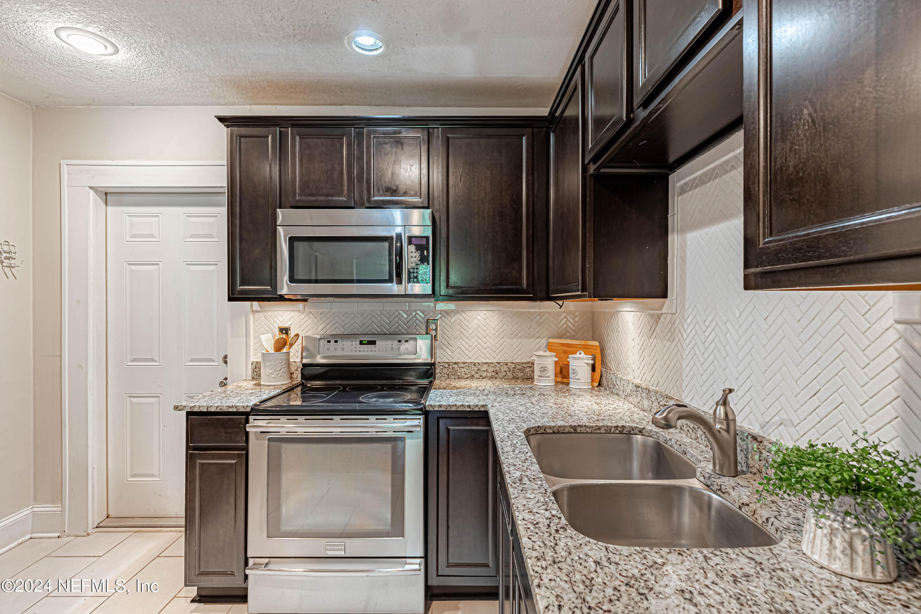 725 Cherokee Street Jacksonville, FL 32205 - Photo 16 of 41 a kitchen with granite countertop a sink stainless steel appliances and cabinets