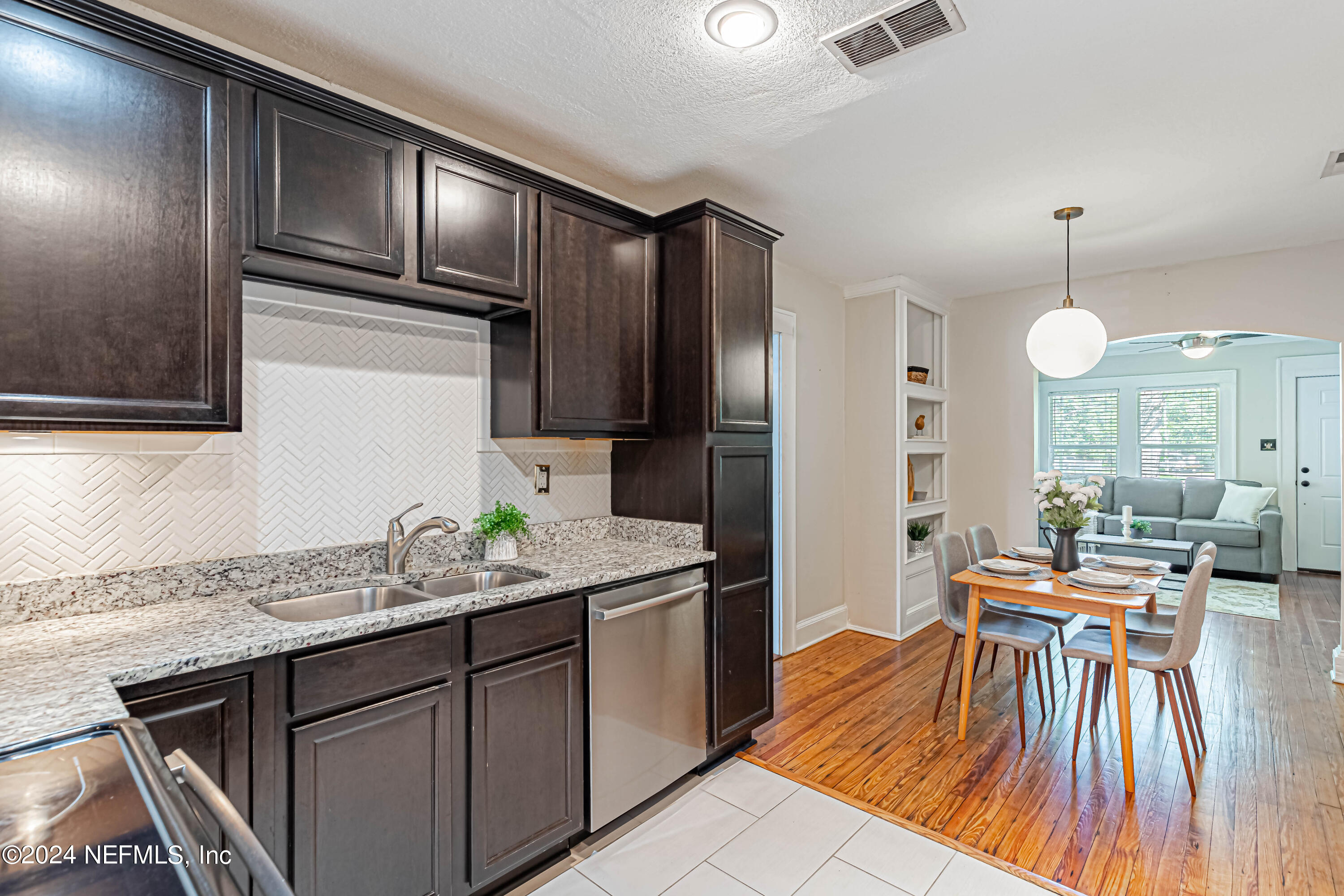 725 Cherokee Street Jacksonville, FL 32205 - Photo 18 of 41 a kitchen with stainless steel appliances granite countertop a sink refrigerator and microwave