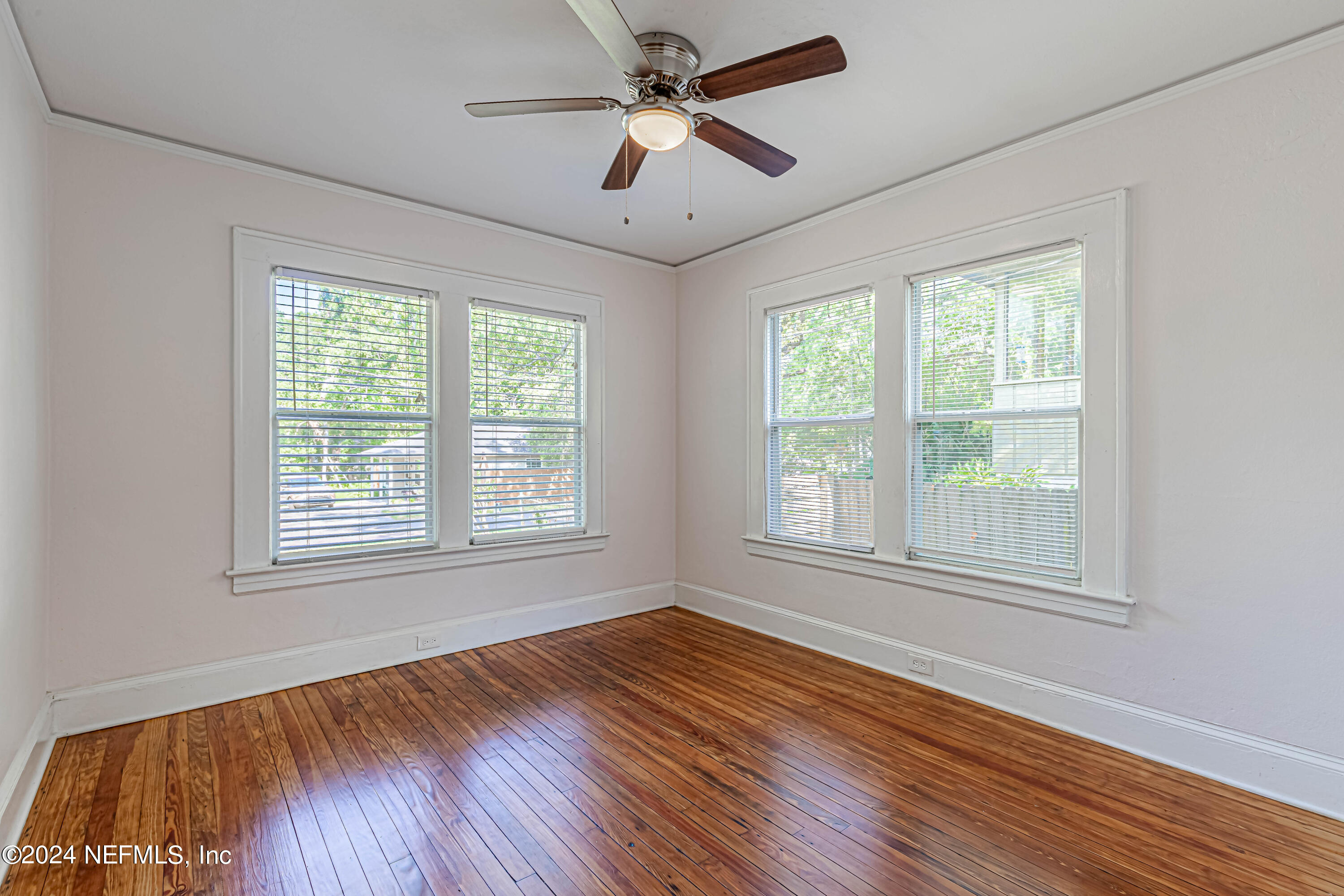 725 Cherokee Street Jacksonville, FL 32205 - Photo 20 of 41 a view of an empty room with wooden floor and a window