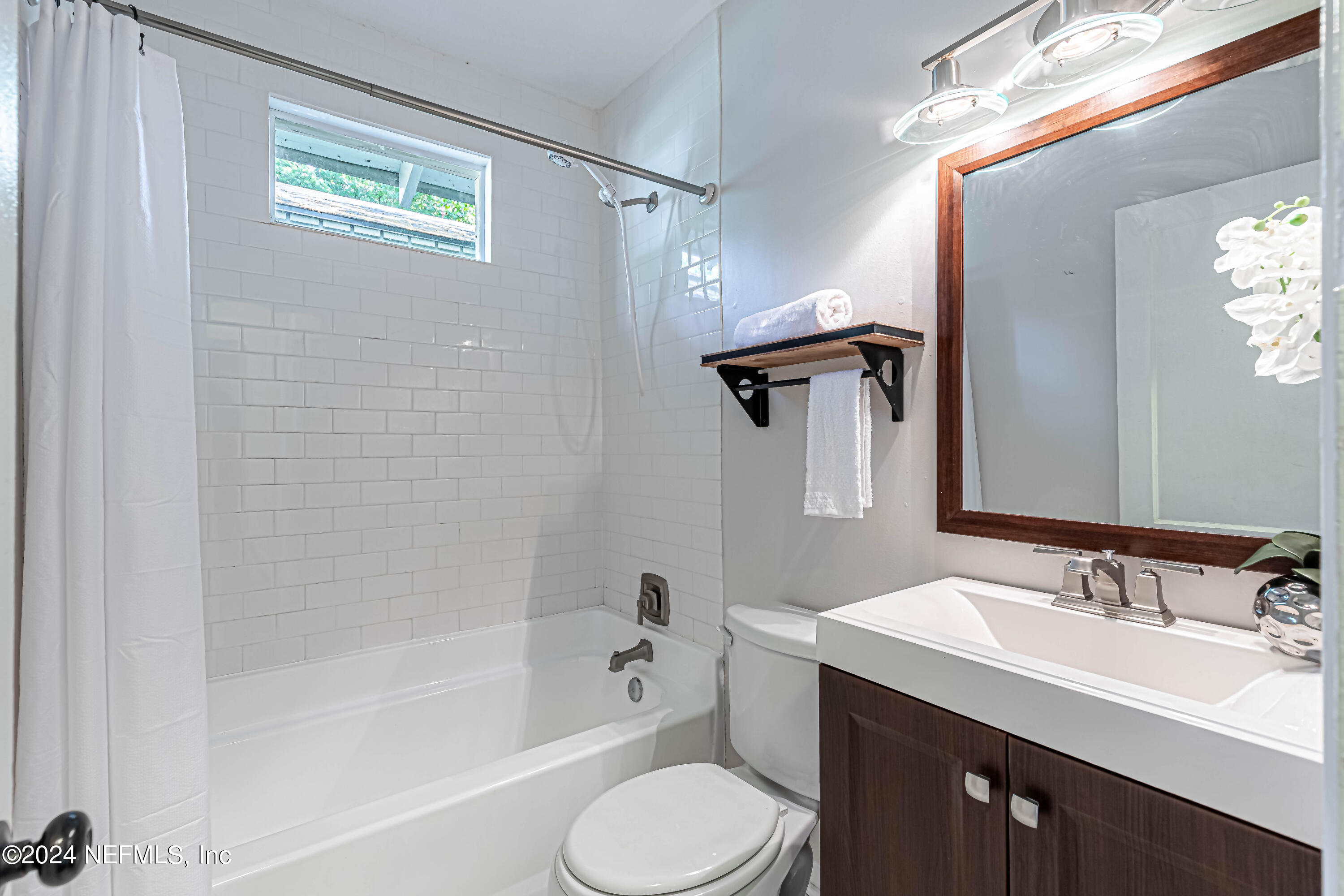 725 Cherokee Street Jacksonville, FL 32205 - Photo 22 of 41 a bathroom with a sink toilet a vanity and shower