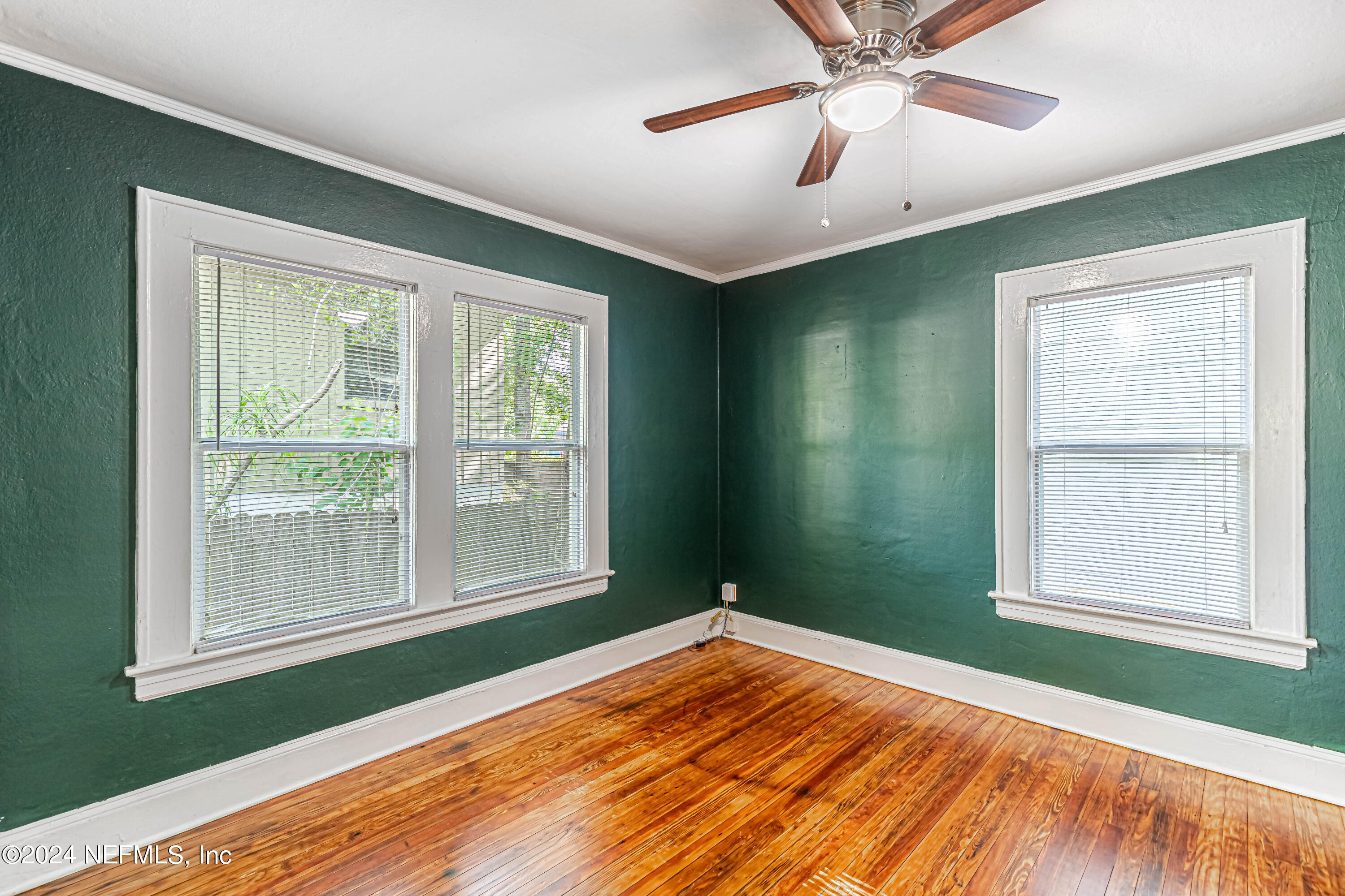 725 Cherokee Street Jacksonville, FL 32205 - Photo 23 of 41 a view of an empty room with wooden floor and a window