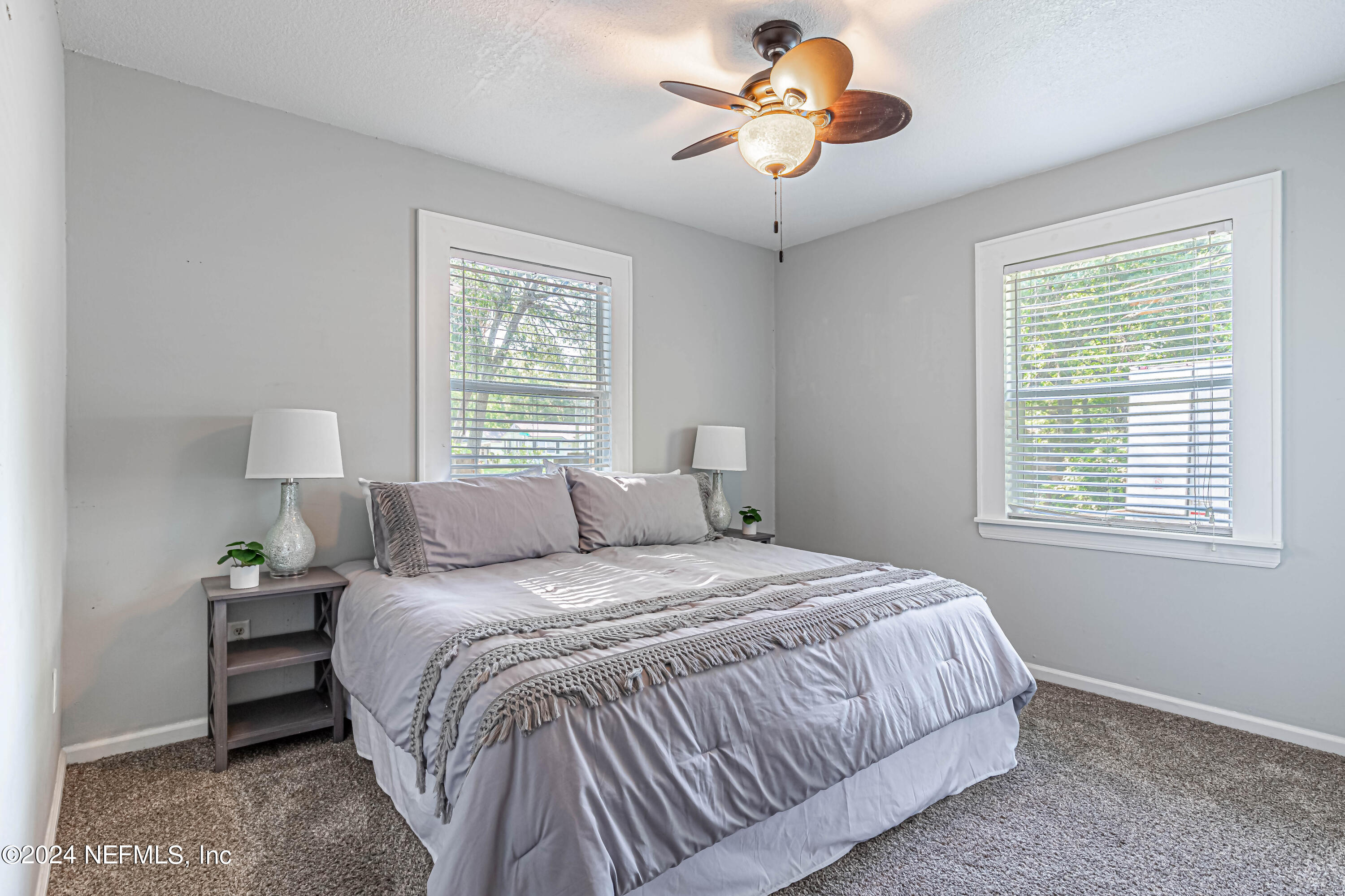 725 Cherokee Street Jacksonville, FL 32205 - Photo 25 of 41 a bedroom with a bed and a chandelier