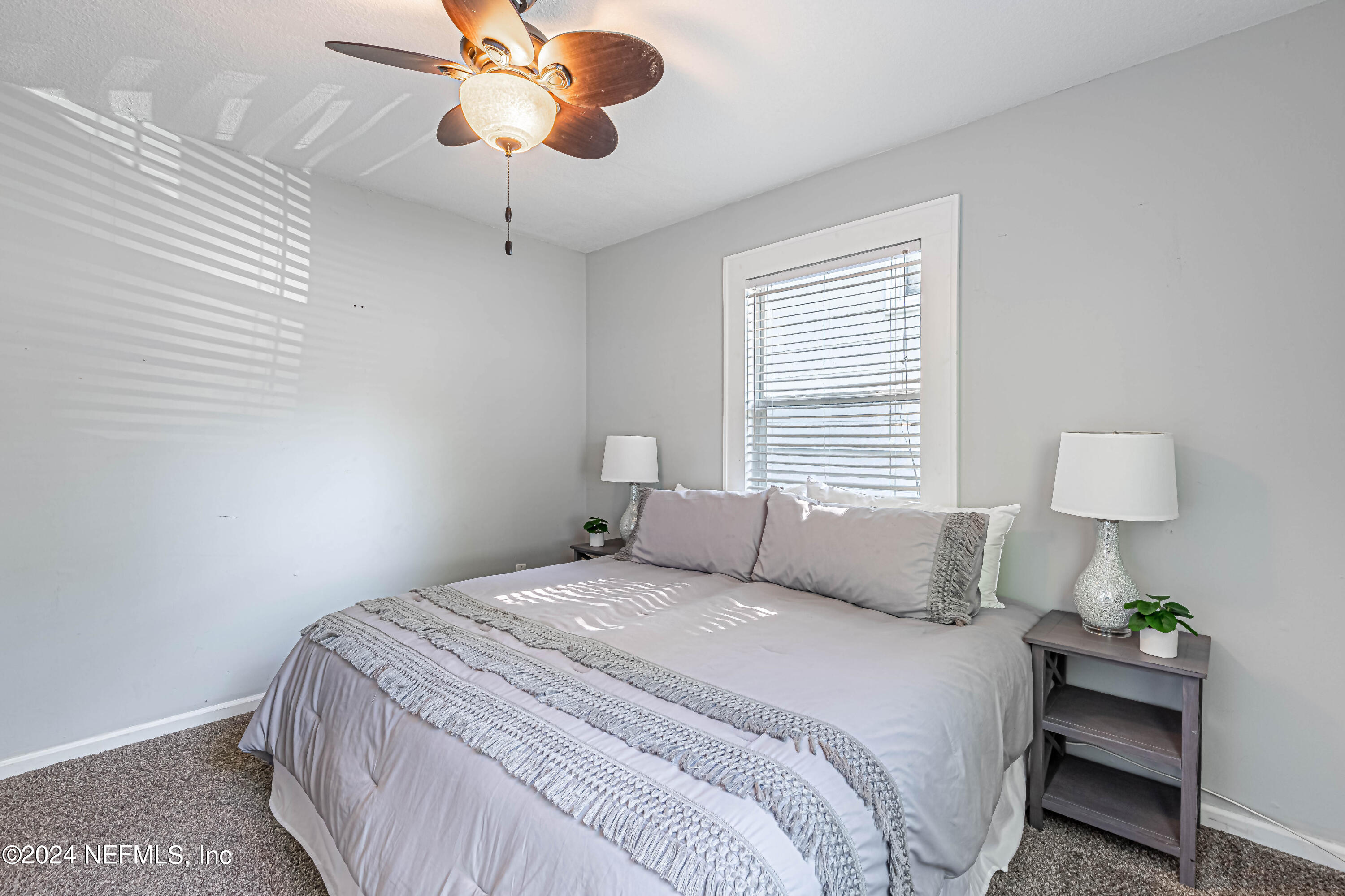 725 Cherokee Street Jacksonville, FL 32205 - Photo 26 of 41 a bedroom with a bed and a lamp