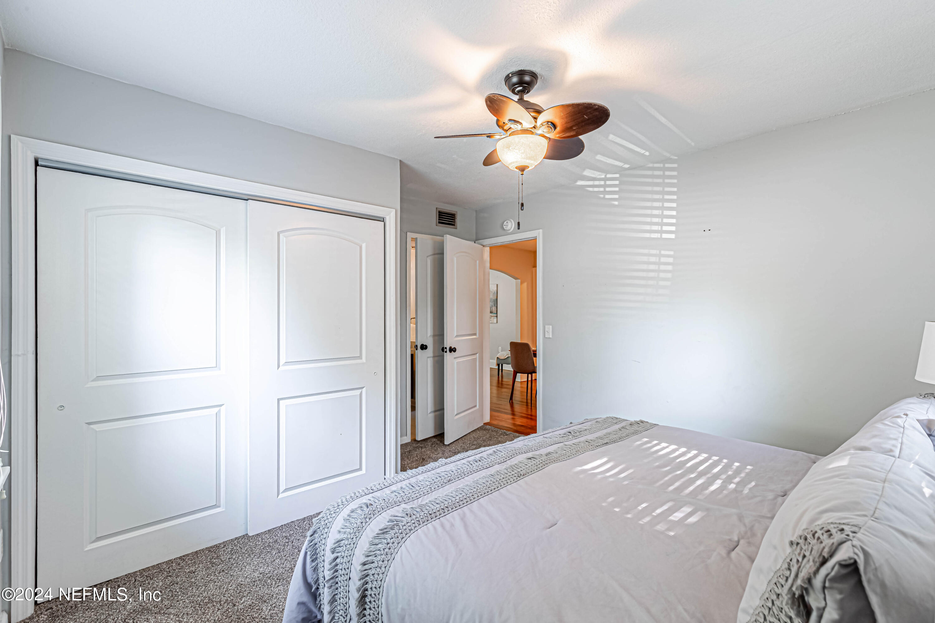 725 Cherokee Street Jacksonville, FL 32205 - Photo 27 of 41 a bedroom with a bed and a chandelier