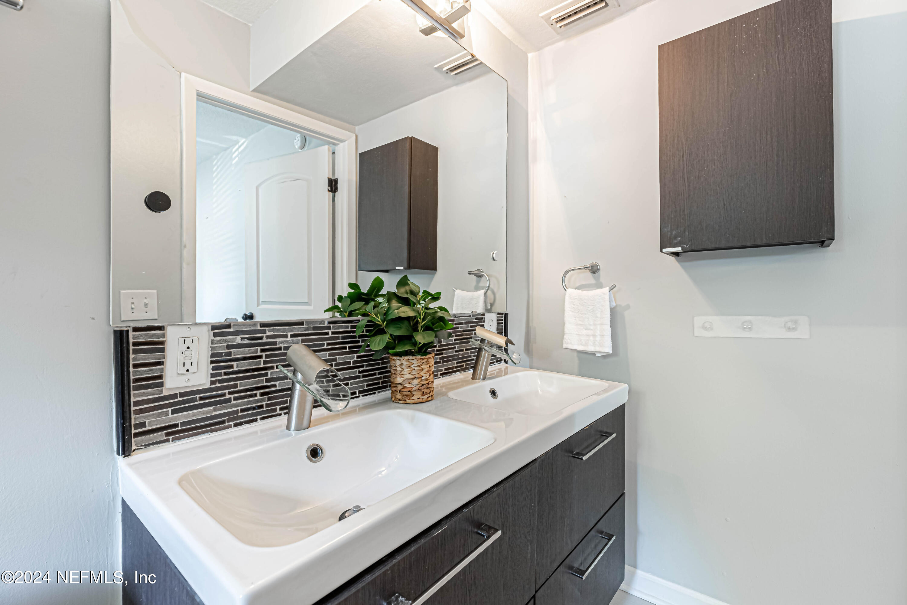 725 Cherokee Street Jacksonville, FL 32205 - Photo 31 of 41 a bathroom with a sink and a mirror