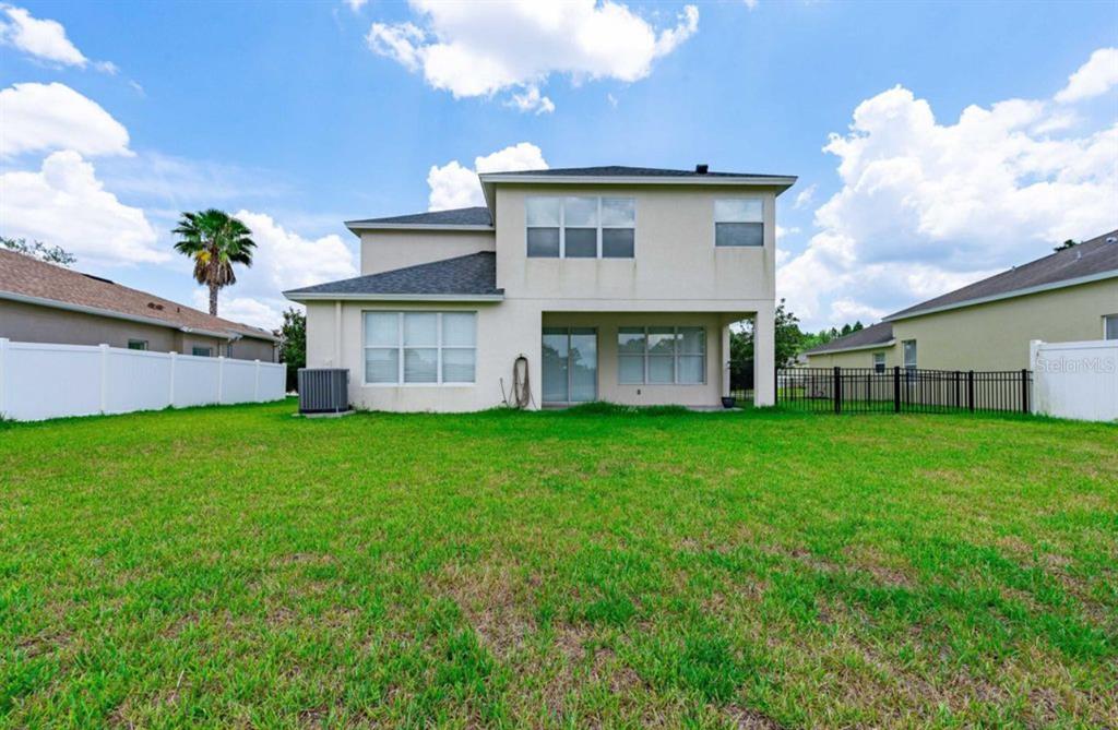 3533 Juneberry Drive Wesley Chapel, FL 33543 - Photo 11 of 12 a view of a house with a back yard