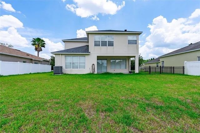 a view of a house with a back yard