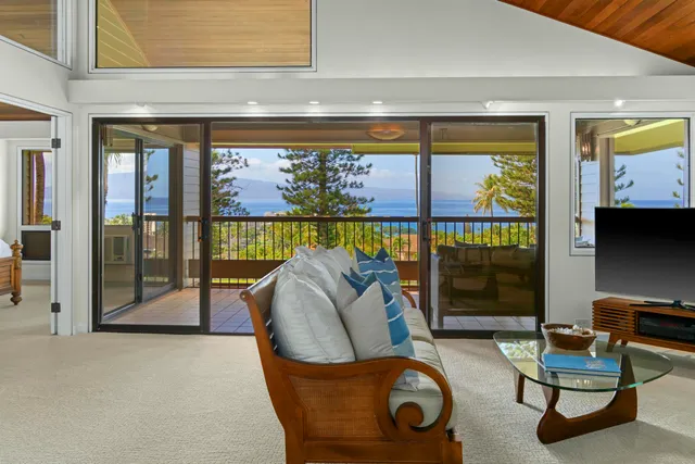 a living room with furniture and a floor to ceiling window