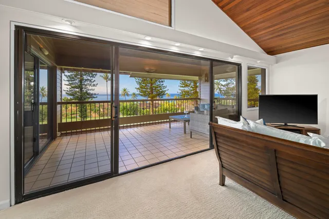 a hallway with a large window and couch
