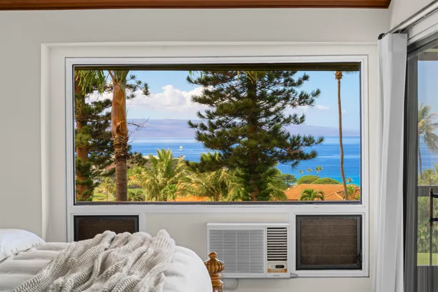 a view of a balcony with a floor to ceiling window and wooden floor