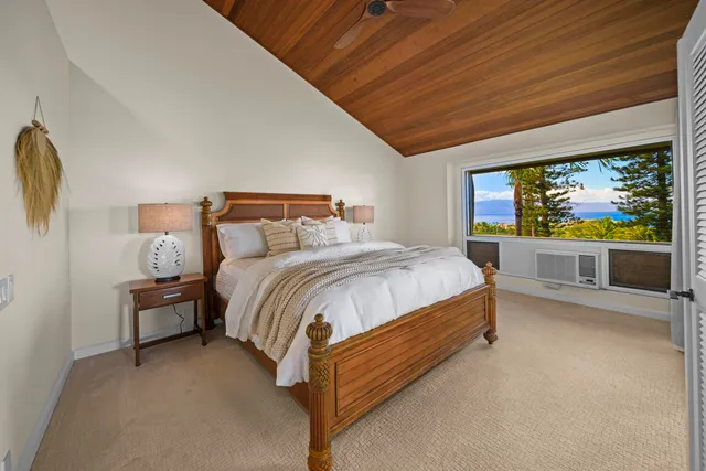 a bed sitting in a bedroom next to a large window