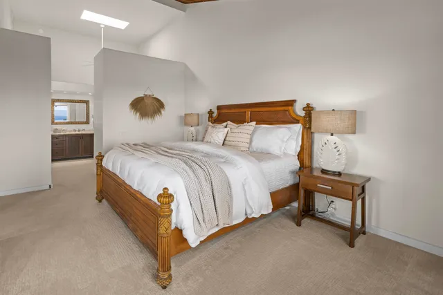 a bedroom with a bed and a lamp