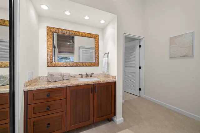 a bathroom with a granite countertop sink mirror and a