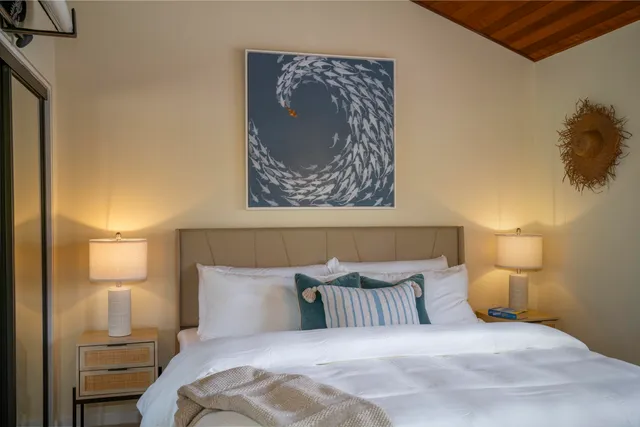 a bedroom with a bed and a lamp