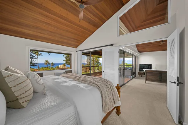 a spacious bedroom with a bed and a large mirror