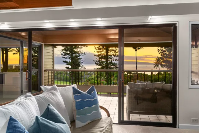a living room with couch and a floor to ceiling window