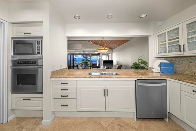 a kitchen with cabinets appliances and a window