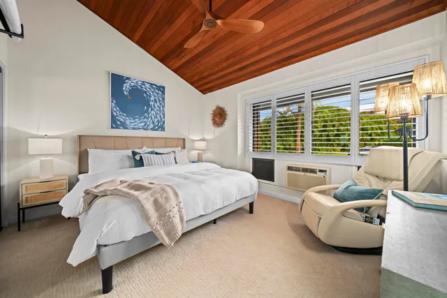 a spacious bedroom with a bed and a couch