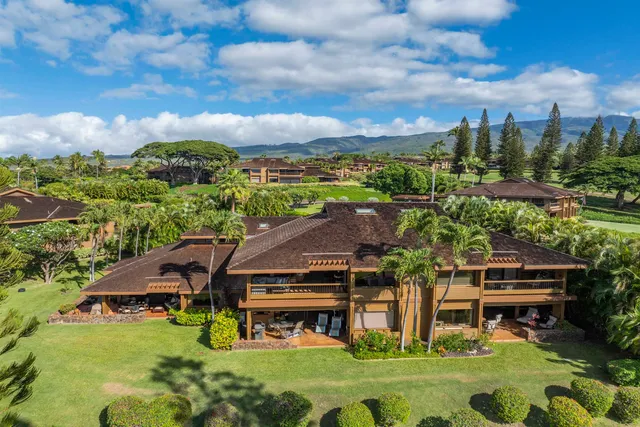 a aerial view of a house with swimming pool and a yard