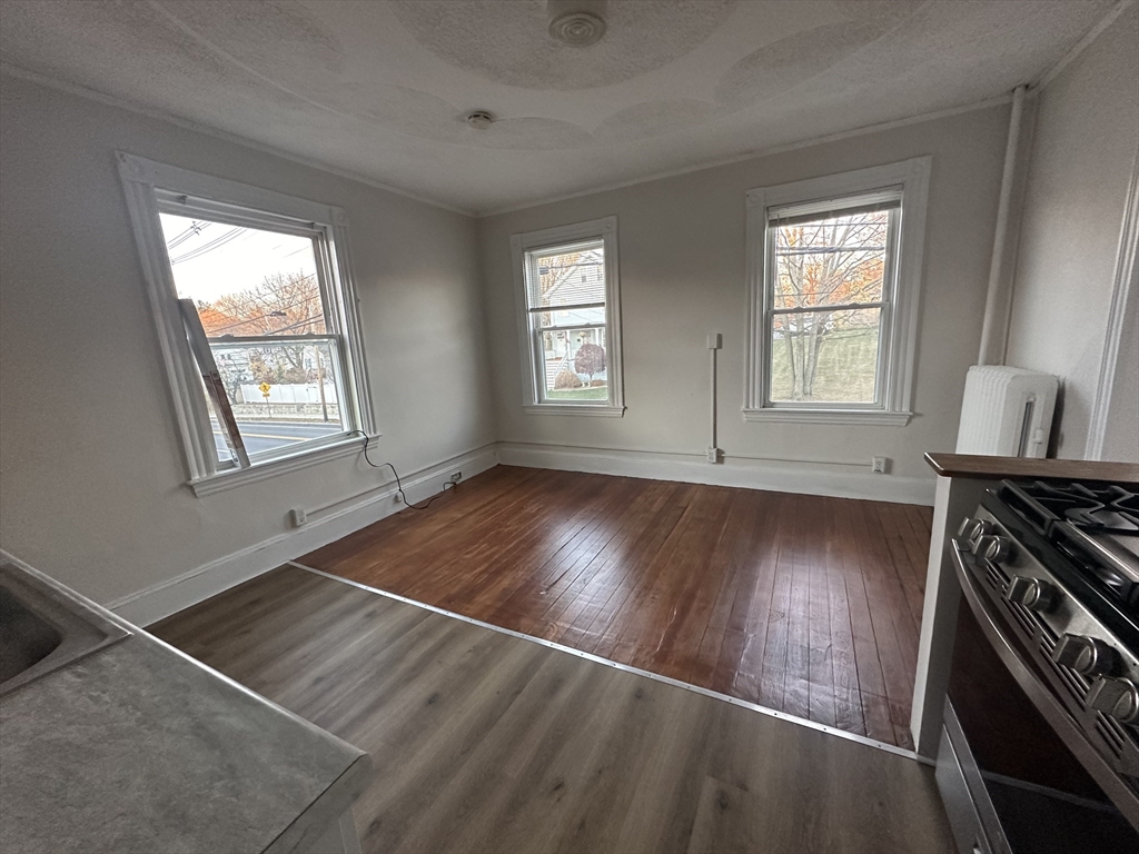 26 North Main Street, Unit 4 Natick, MA 01760 - Photo 3 of 13 a view of an empty room with wooden floor and a window