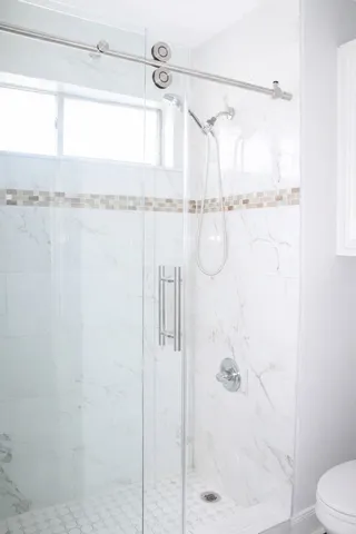 a bathroom with a shower and a toilet