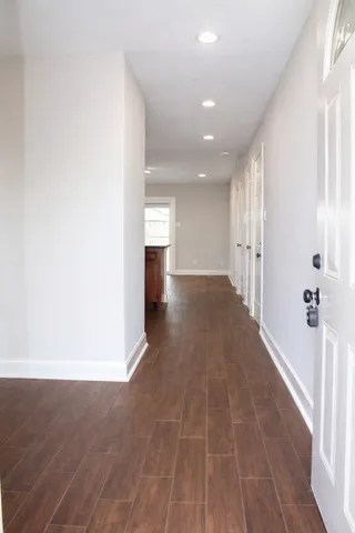 a view of a hallway with wooden floor