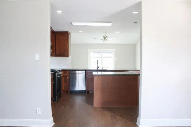 a view of a kitchen with a sink and a window