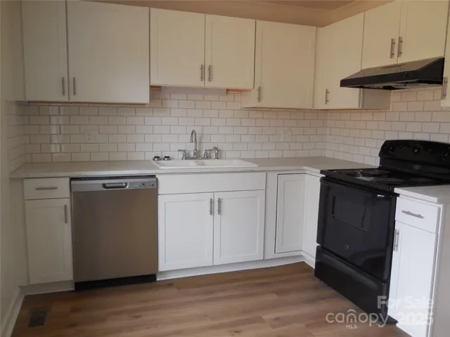 a kitchen with a sink and cabinets