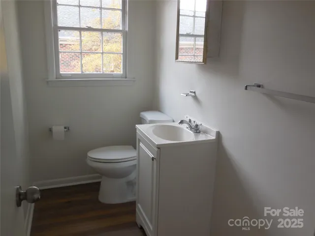 a bathroom with a sink toilet and window